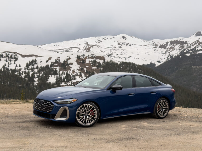 Audi S5 parked on an overlook at 12,000 feet, with snowy mountains in the background.