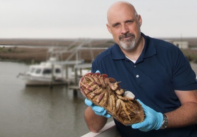 Craig McClain holding a giant isopod (Bathynomus giganteus), one of the deep sea’s most iconic crustaceans