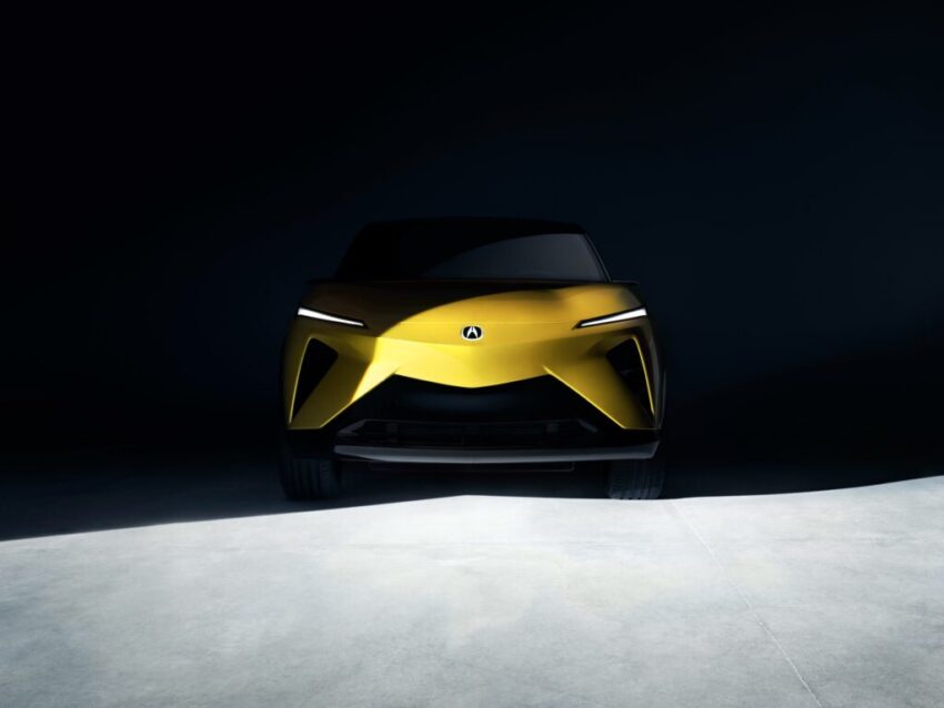 The nose of a yellow Acura RDX, shrouded in shadow