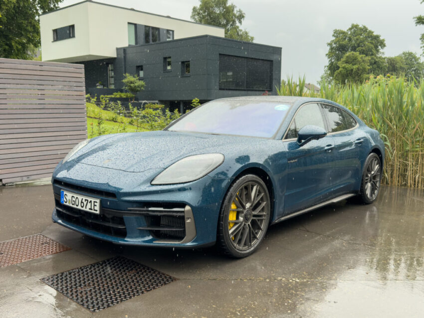 A blue Porsche Panamera Turbo S in the rain