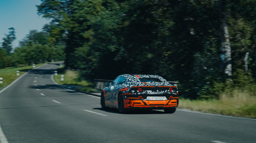 A camo-wrapepd Mercedes prototype drives away from the camera