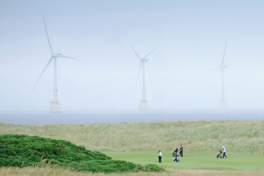 golf course with wind farm in background